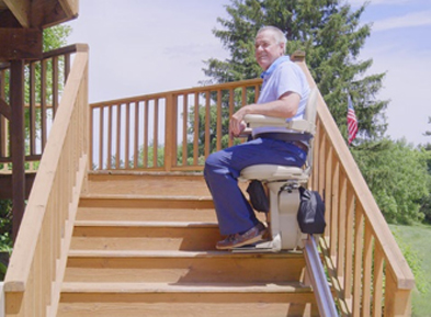 Man riding on an outdoor stairlift